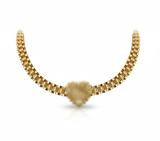 Gold necklace with a heart-shaped pendant on a white background