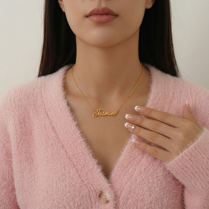 Woman wearing a gold 'Jasmine' necklace with a plain background
