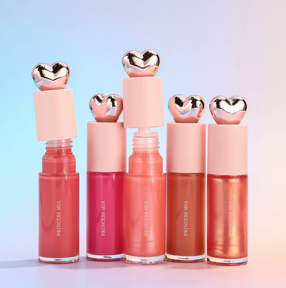 Set of five lip glosses with heart-shaped caps on a gradient background