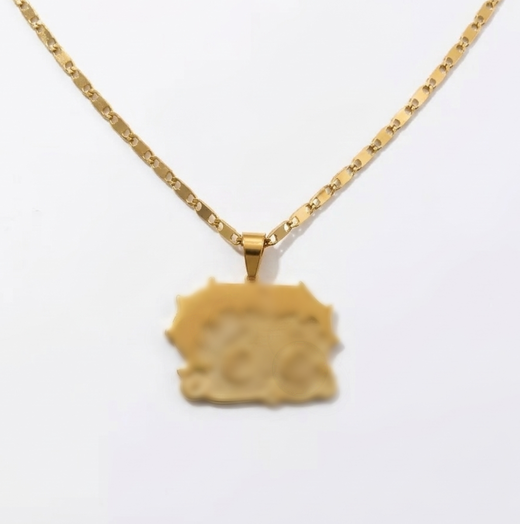Gold necklace with a textured pendant on a white background