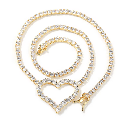 Gold necklace with heart-shaped pendant on a white background