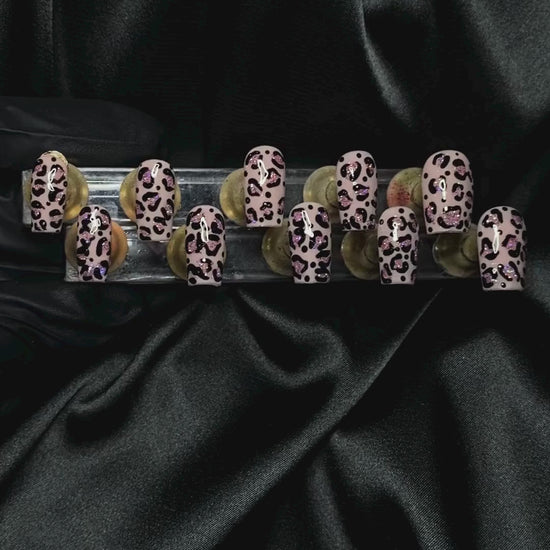 Shimmering crystal nail art display on luxurious black satin background from PrincessMiaNailz.