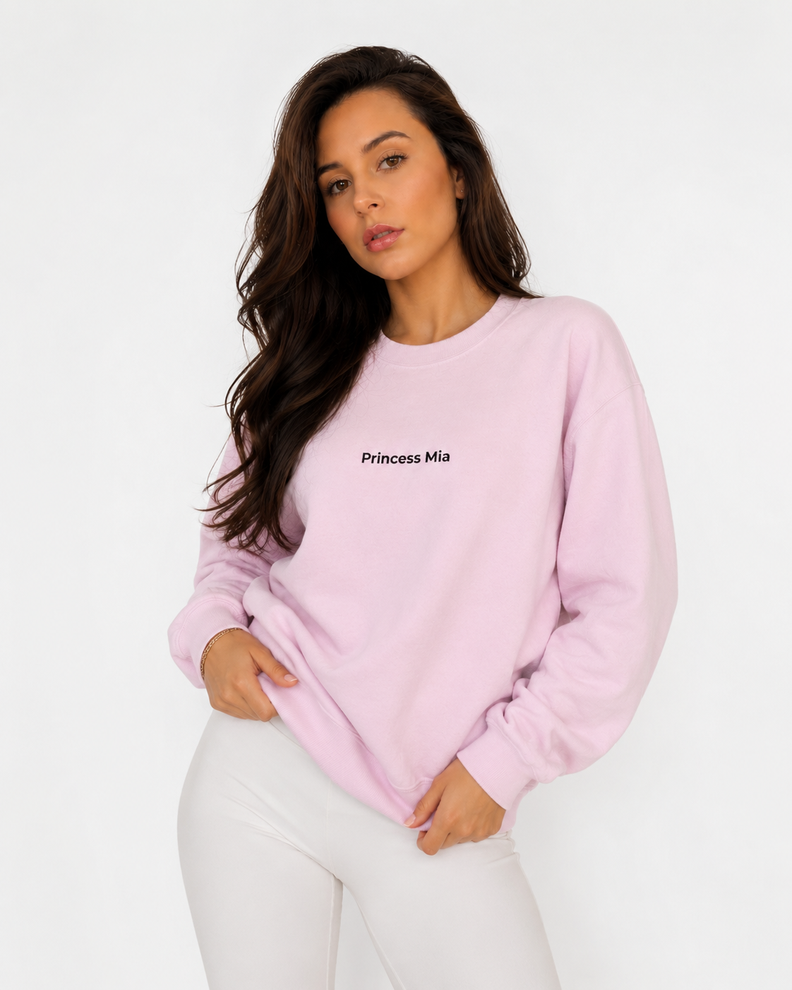 Woman wearing a pink sweatshirt with 'Princess Mia' text on a white background