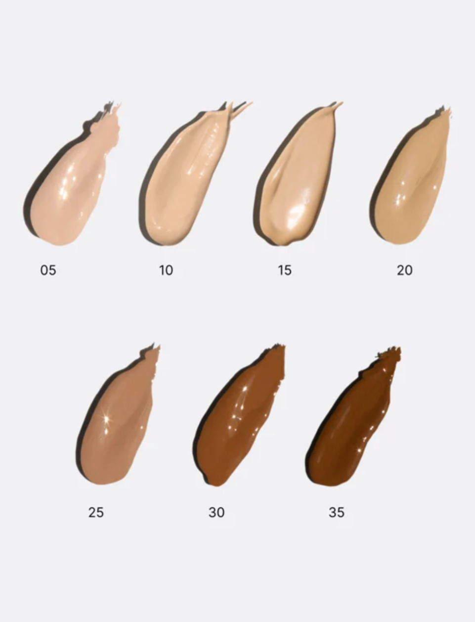Set of foundation swatches in various shades on a light gray background