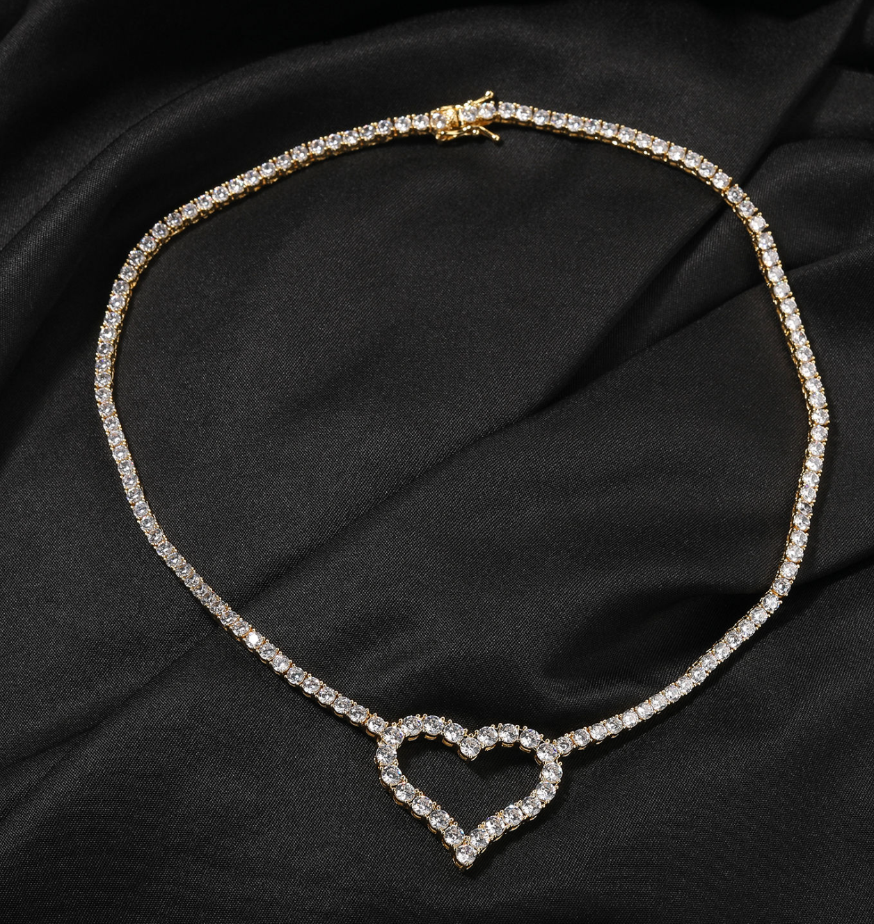 Necklace with a heart-shaped clasp on a black fabric background
